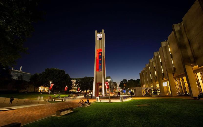 Temples iconic belltower lit red at night